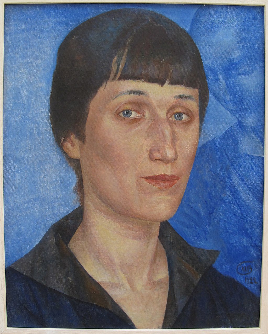 Portrait of Anna Akhmatova, a middle-aged looking woman with thin facial features and short, brown hair. She's got blue eyes and is looking directly at the viewer.